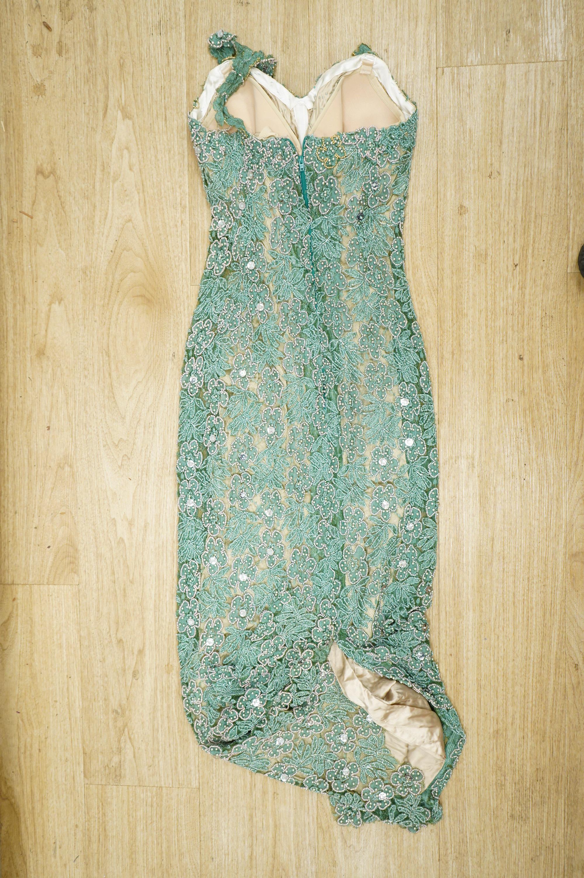 A 1960’s-70’s light green beaded and sequin floral net, fitted full length evening dress. 134cm long